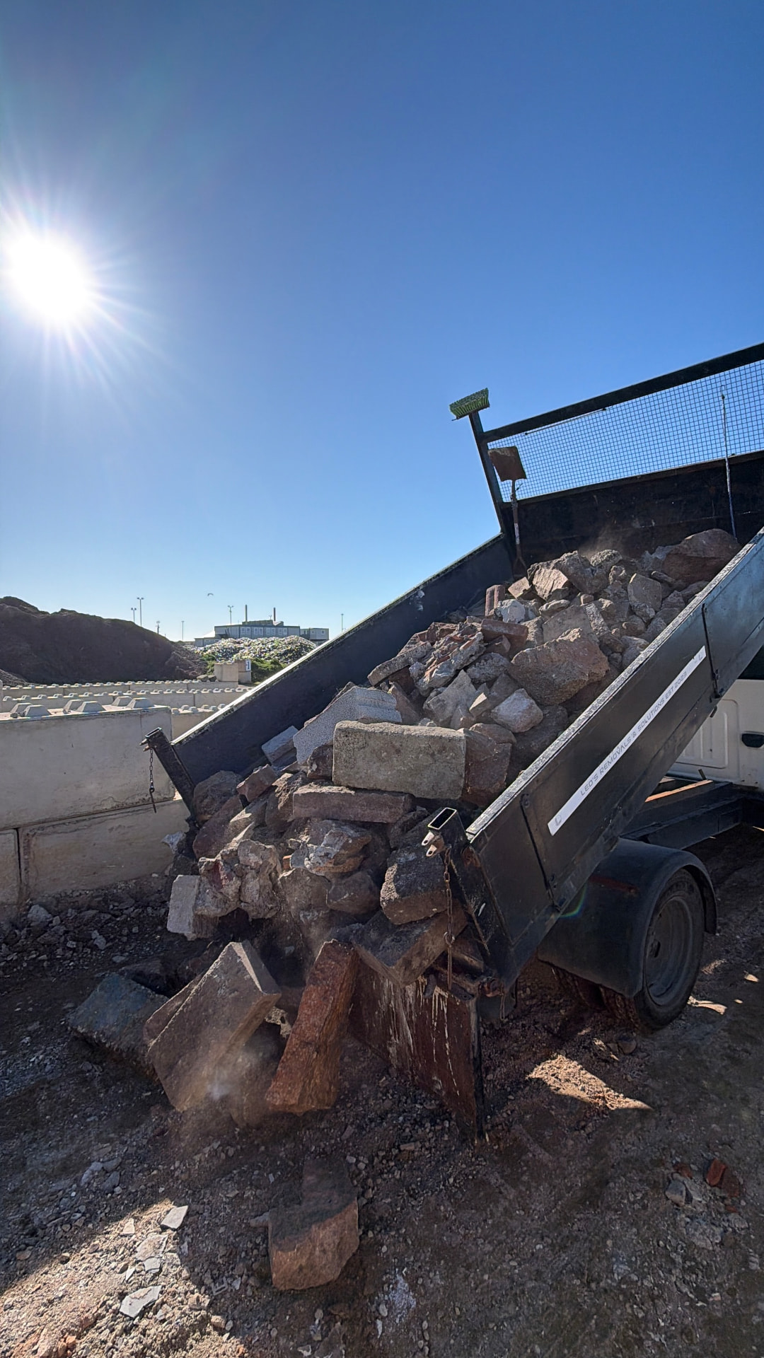 Tipper truck tipping a load of rubble and bricks